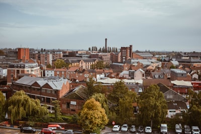 cars parked on parking lot near houses during daytime york teams background