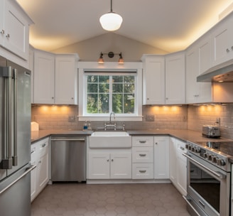 white wooden kitchen cabinet with white pendant lamp