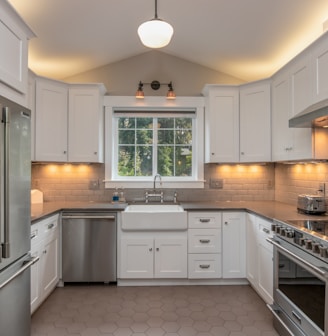 white wooden kitchen cabinet with white pendant lamp