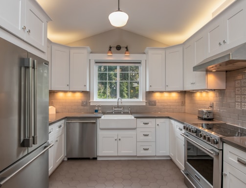 white wooden kitchen cabinet with white pendant lamp