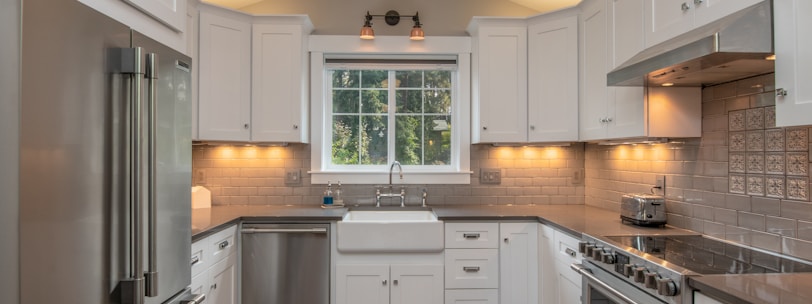 white wooden kitchen cabinet with white pendant lamp