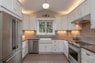 white wooden kitchen cabinet with white pendant lamp