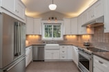 white wooden kitchen remodel cabinet with white pendant lamp