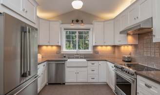 white wooden kitchen cabinet with white pendant lamp