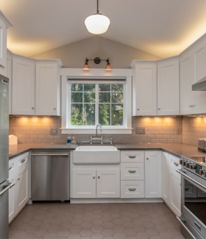 white wooden kitchen cabinet with white pendant lamp