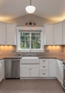 white wooden kitchen cabinet with white pendant lamp