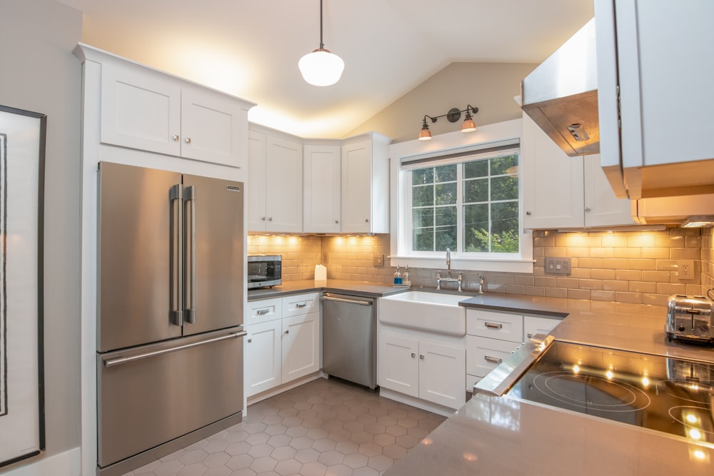 white wooden kitchen cabinet and white pendant lamp