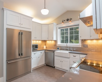 white wooden kitchen cabinet and white pendant lamp