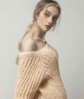 woman in beige knit off shoulder top