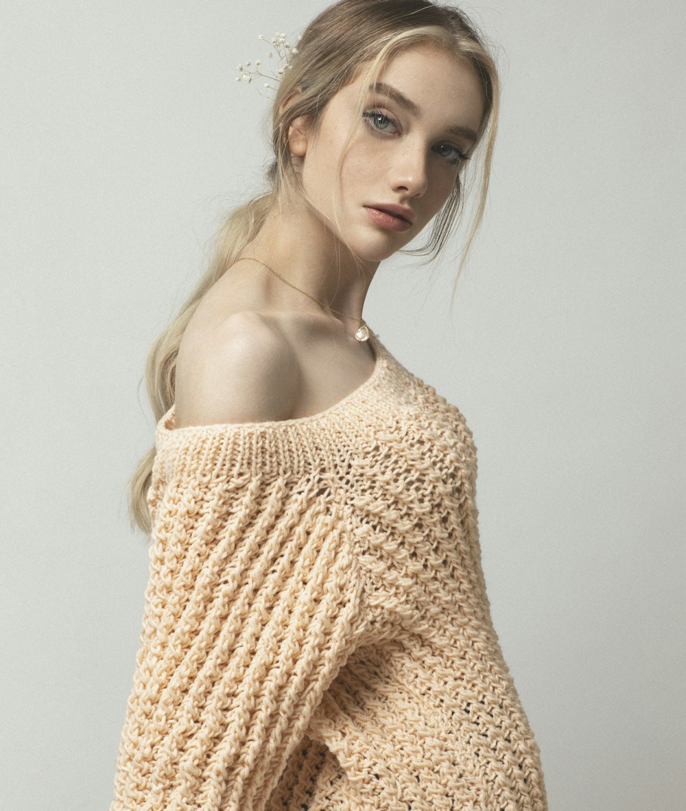 woman in beige knit off shoulder top