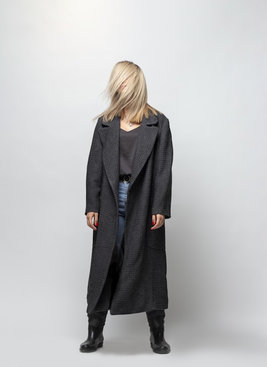 woman in gray coat standing
