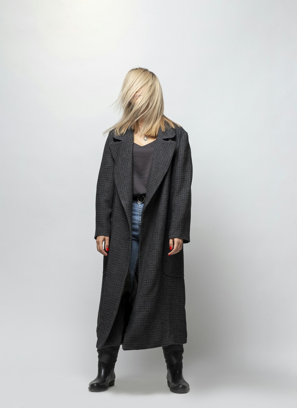 woman in gray coat standing