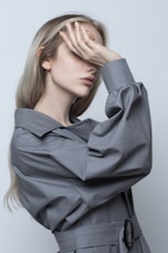 woman in black long sleeve shirt covering her face