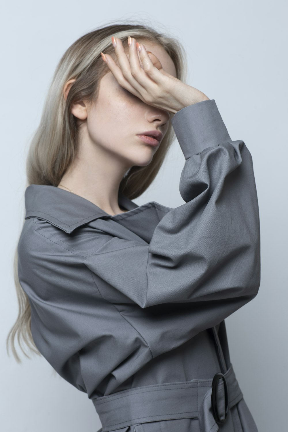 woman in black long sleeve shirt covering her face