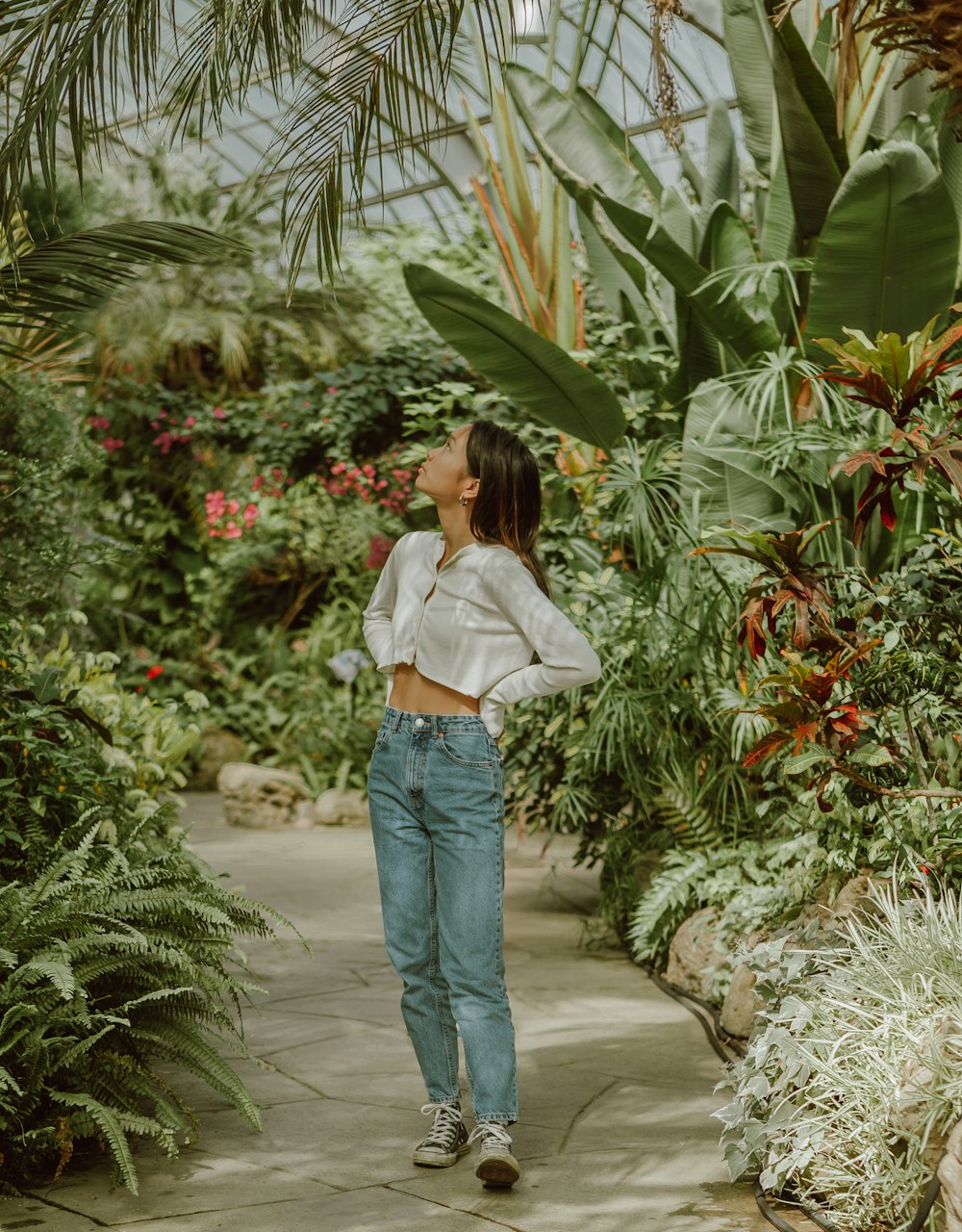 Woman in white shirt and blue denim jeans standing near green plants during  daytime photo – Free Toronto Image on Unsplash