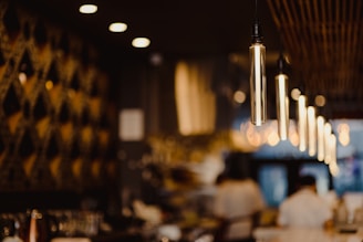 Interior shot of the restaurant with glowing pendant lights and inviting seating.