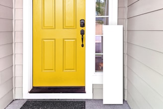 A cozy home entrance fitted with a sleek, custom dog door and a happy dog waiting to go outside.