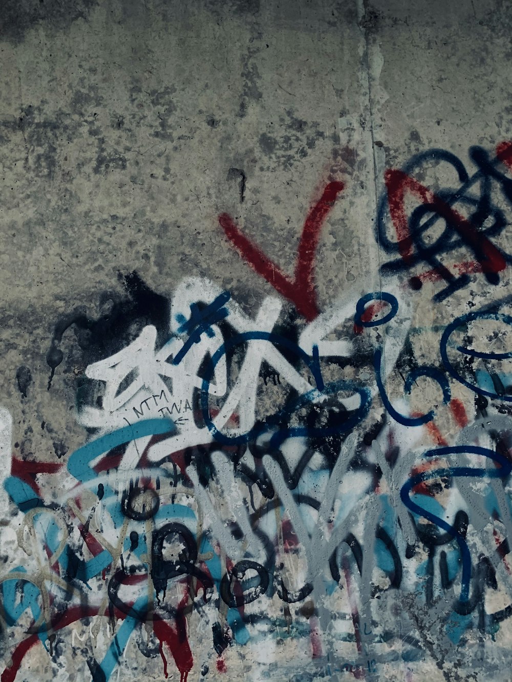 white and red love letter letter on gray concrete floor