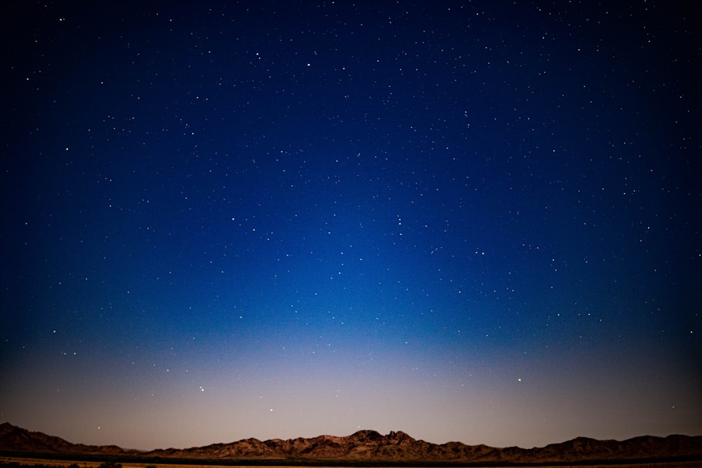 brown mountain under blue sky during night time