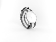 Casual watch with a minimalist design displayed on a fabric background.
