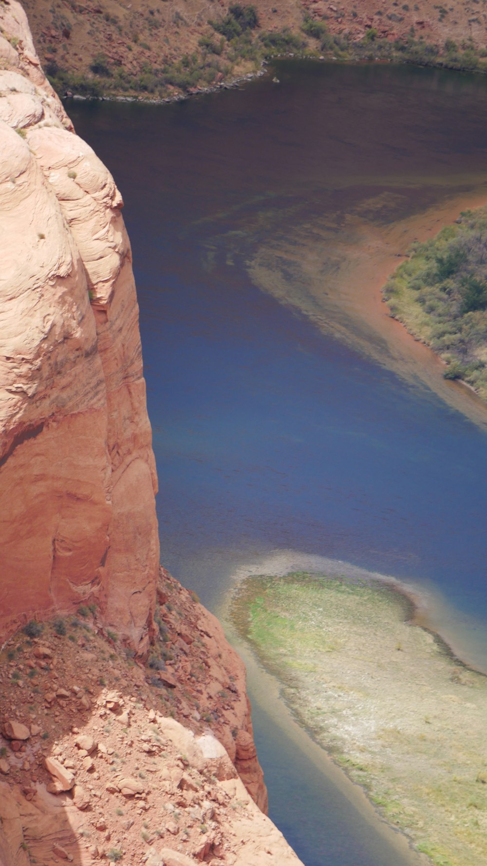 brown rock formation near body of water during daytime