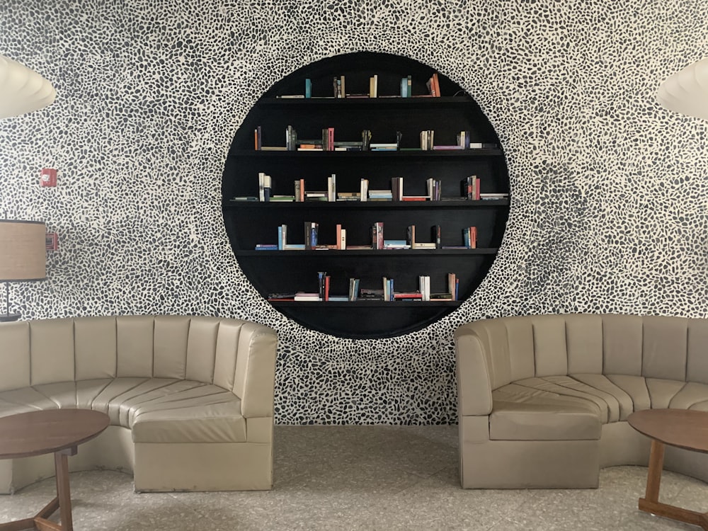 white leather sofa chair near round mirror