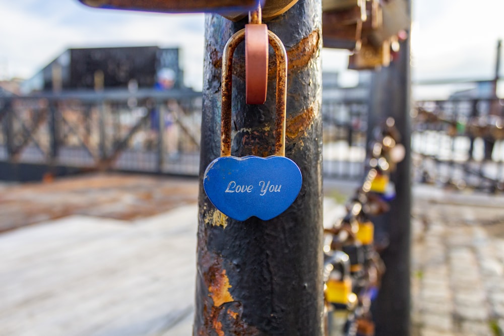 brown wooden padlock on brown metal bar