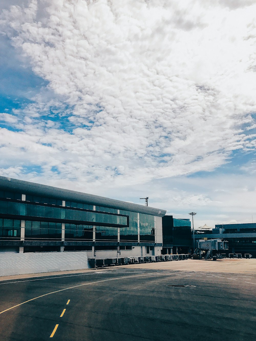 blue and white concrete building under white clouds and blue sky during daytime