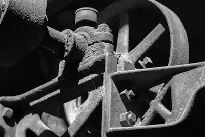 Hands holding a rusty gear wheel, highlighting texture and detail.