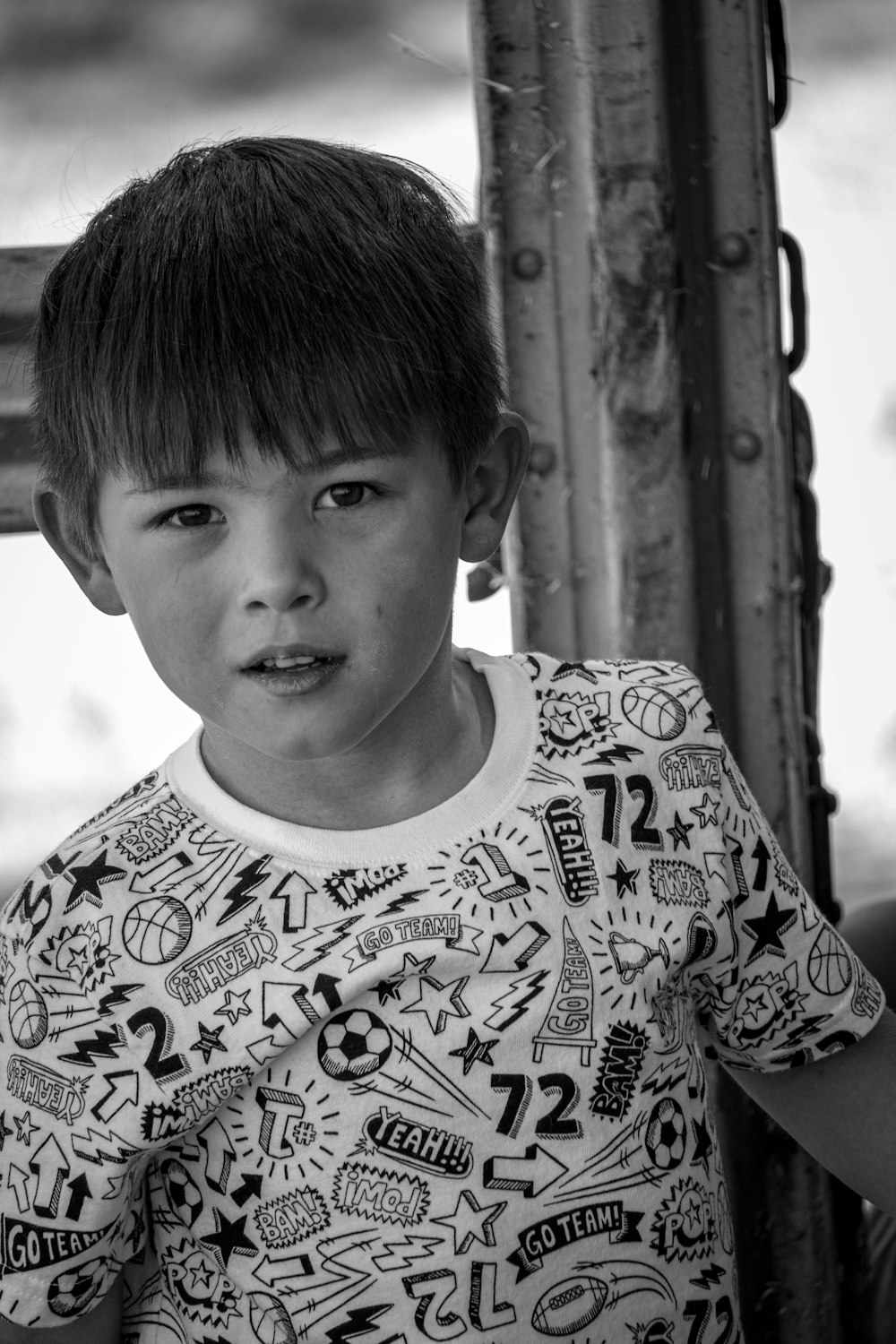 grayscale photo of boy in floral crew neck shirt