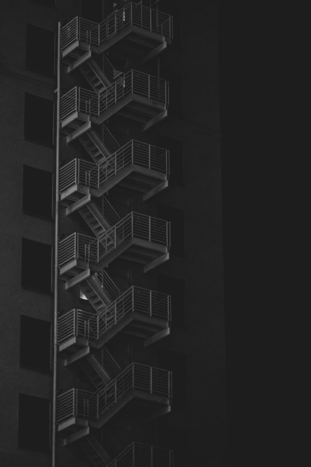 grayscale photo of spiral stairs