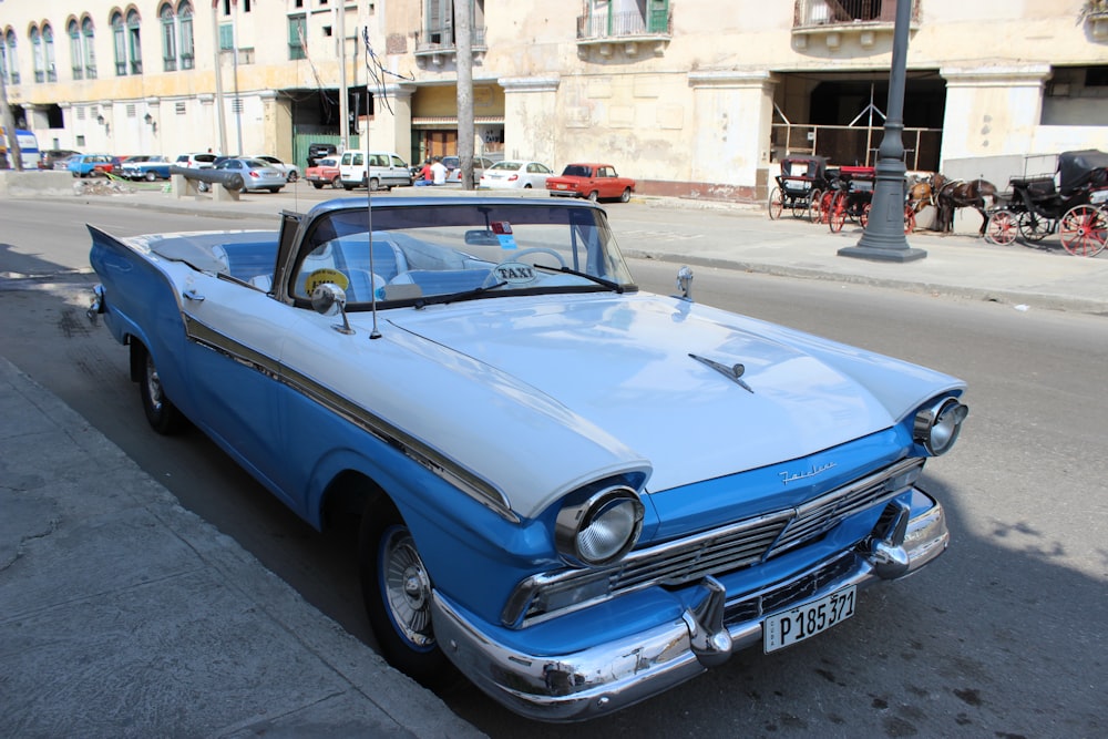 blue classic car on road during daytime