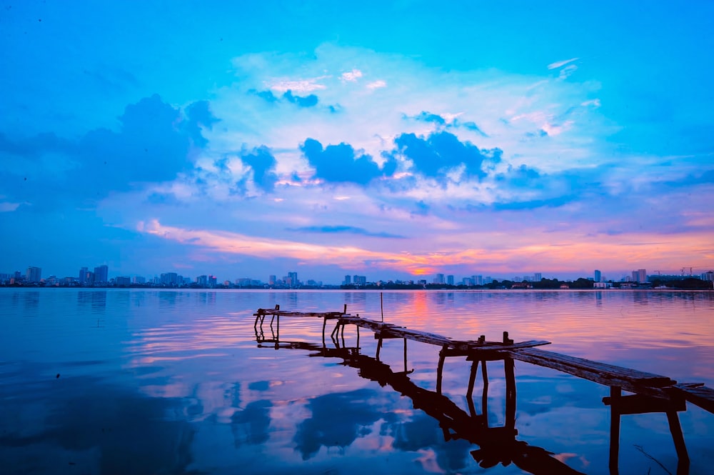 brown wooden dock on body of water during daytime