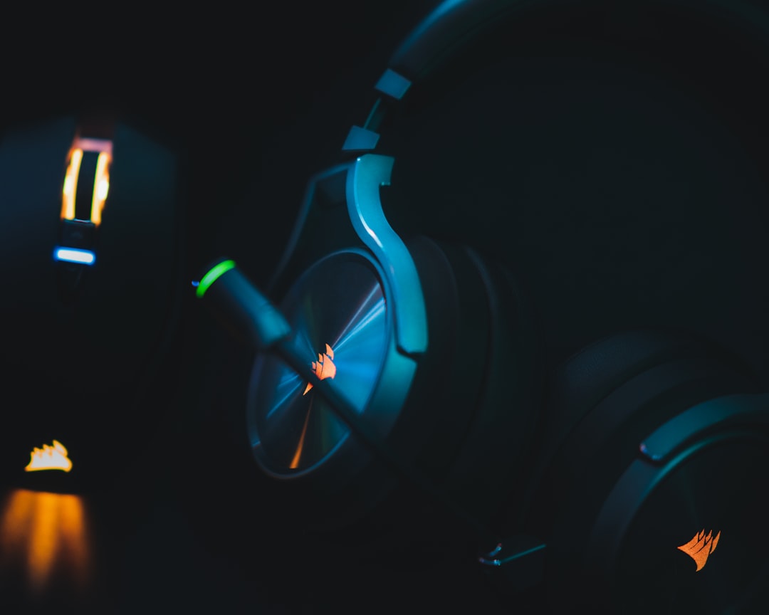 blue and black headphones on black surface