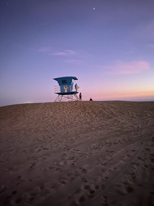 blue and white lifeguard house on sand in San Diego United States