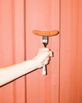 person holding brown wooden handle