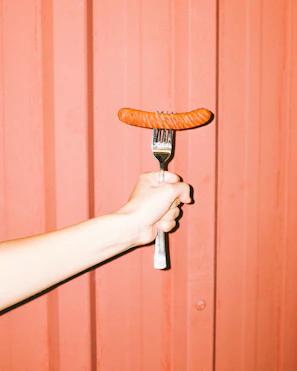 person holding brown wooden handle