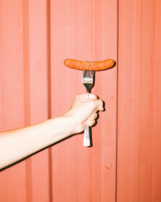 person holding brown wooden handle
