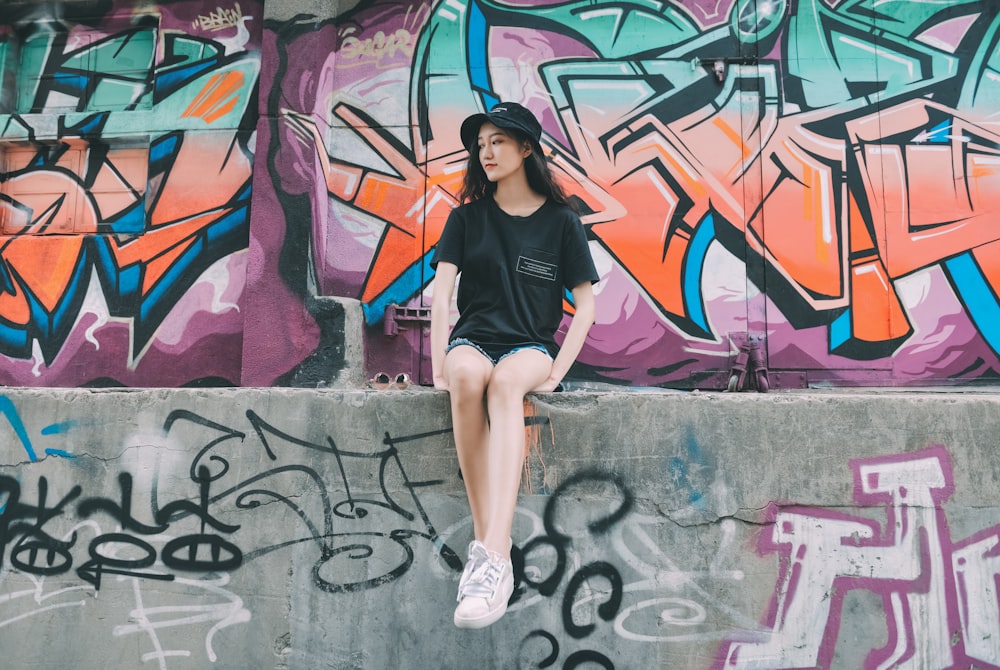 woman in black tank top and gray shorts standing on gray concrete floor