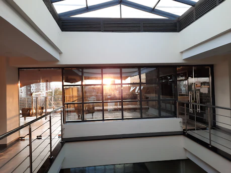 A sparkling clean modern office space with sunlight streaming through large windows.