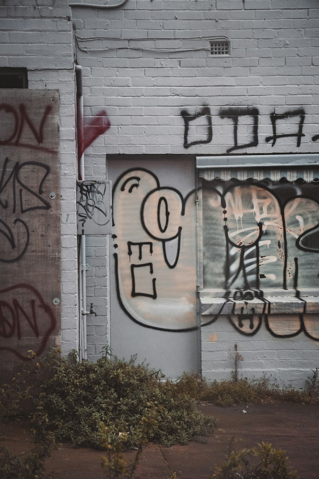 white and black graffiti on white wall