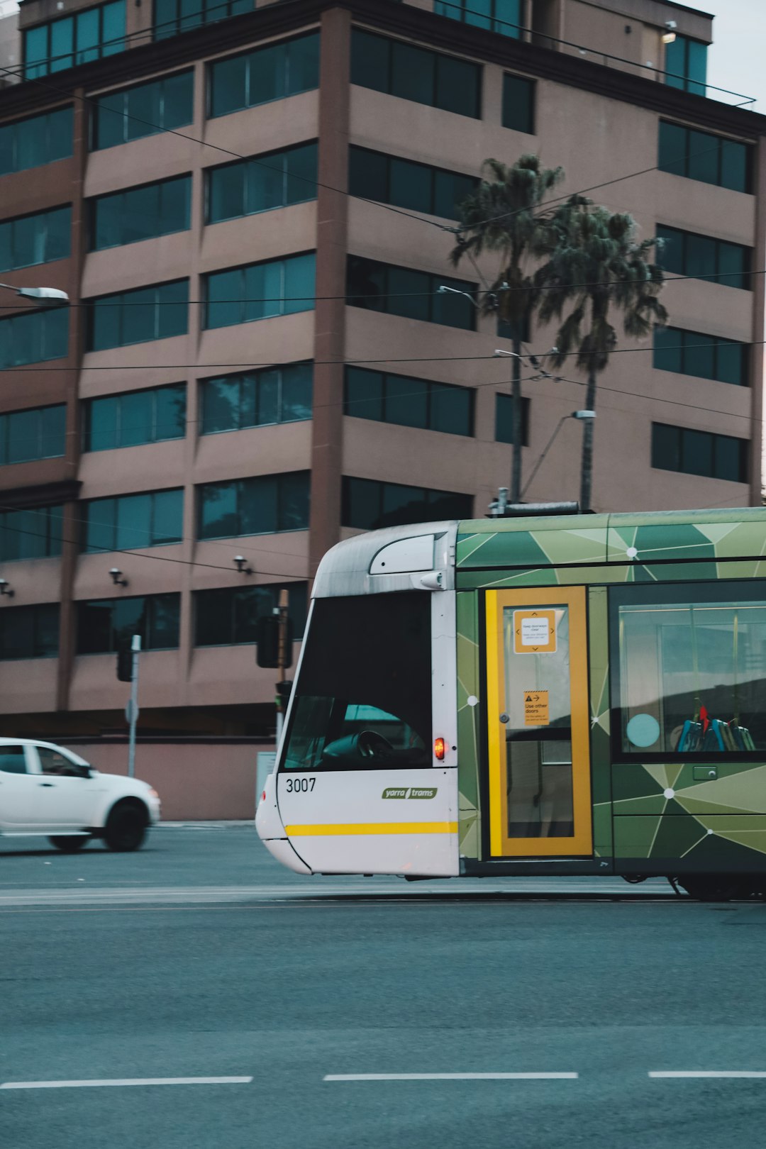 white and green bus on road during daytime