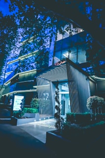 Elegant commercial building entrance highlighted by sleek, modern outdoor lighting fixtures at dusk.