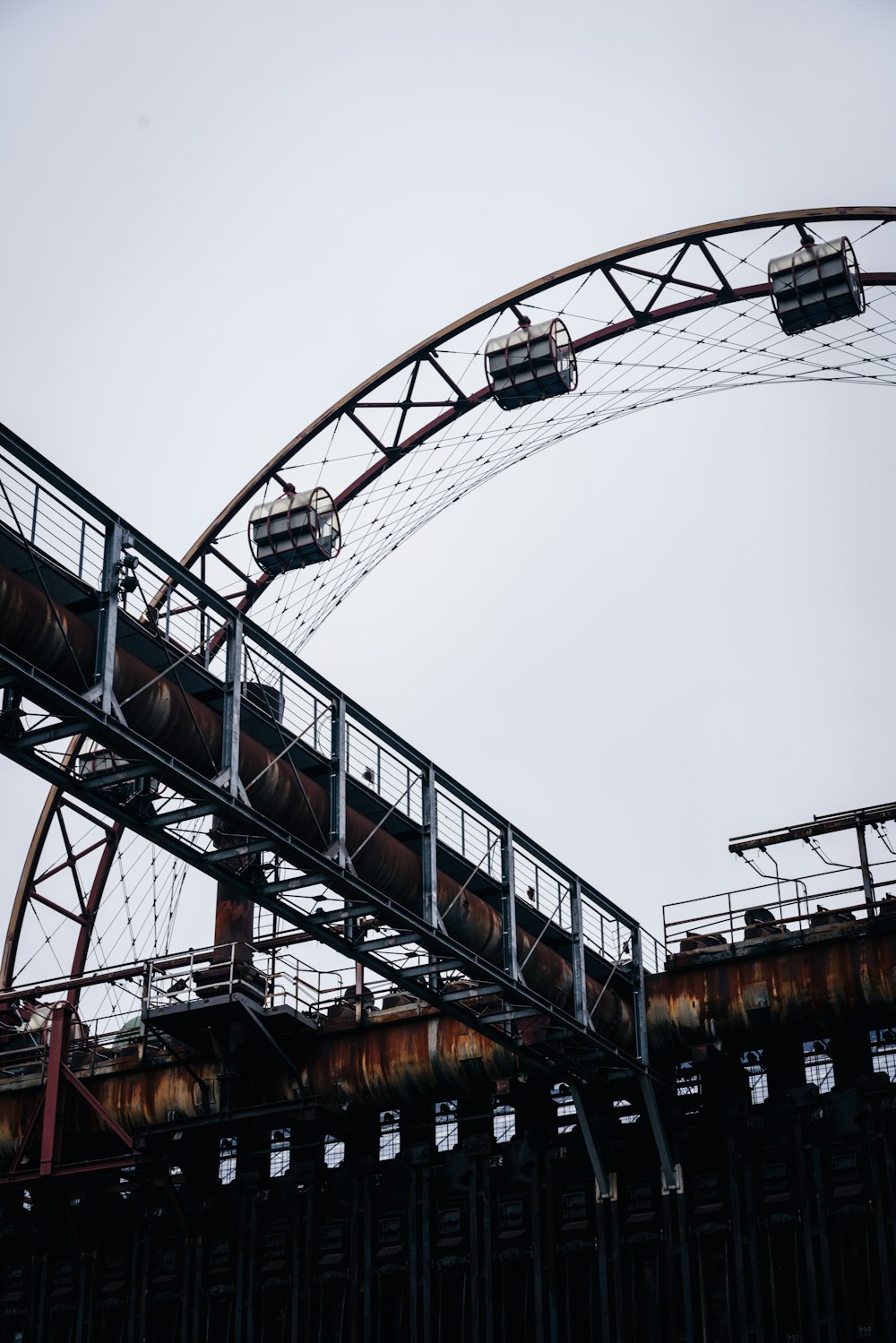 brown and black metal bridge under white sky during daytime