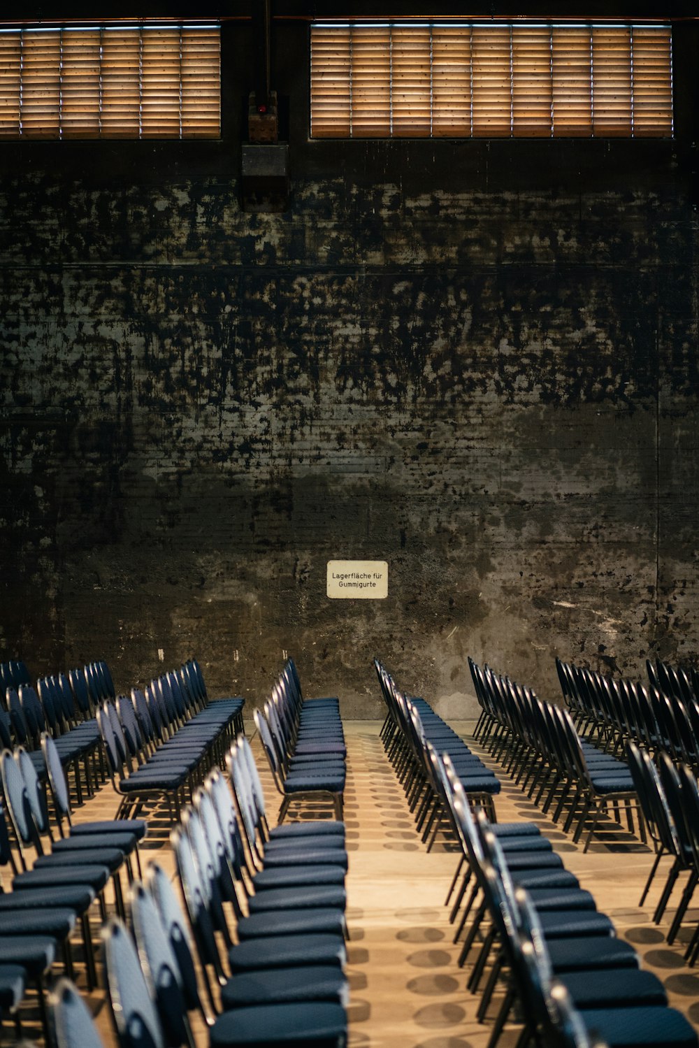 a room filled with lots of blue chairs