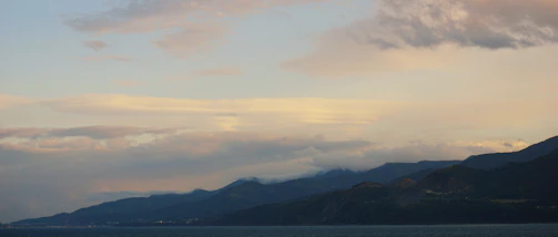 A serene arctic coastline with soft waves under a pale blue sky, evoking calm and connection.