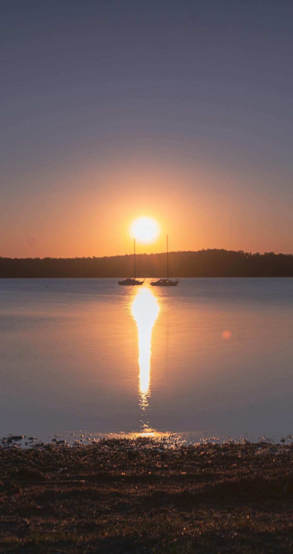 silhouette of boat on sea during sunset