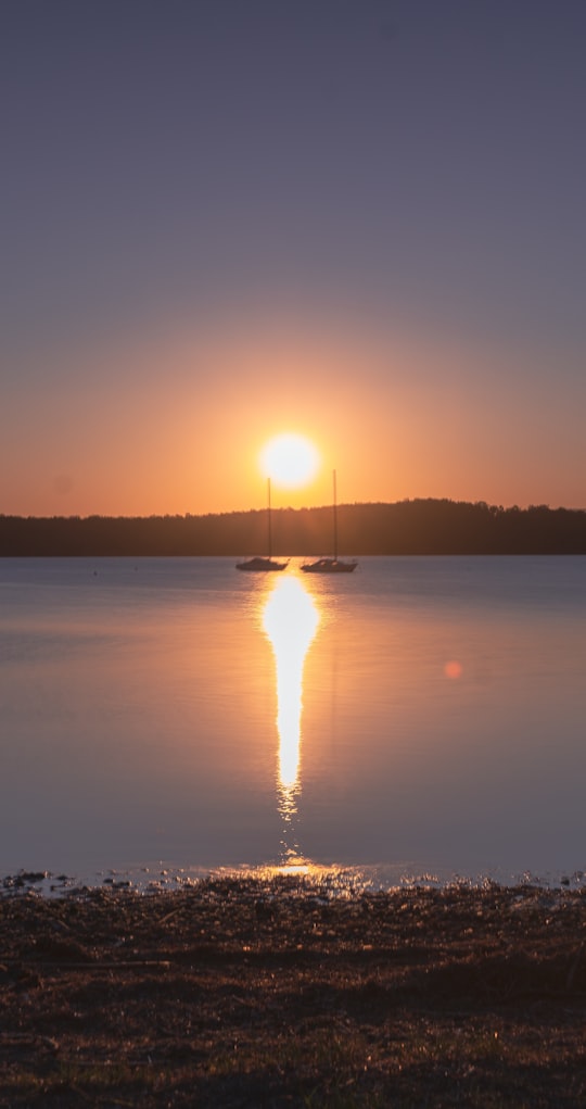 silhouette of boat on sea during sunset in Warners Bay NSW Australia