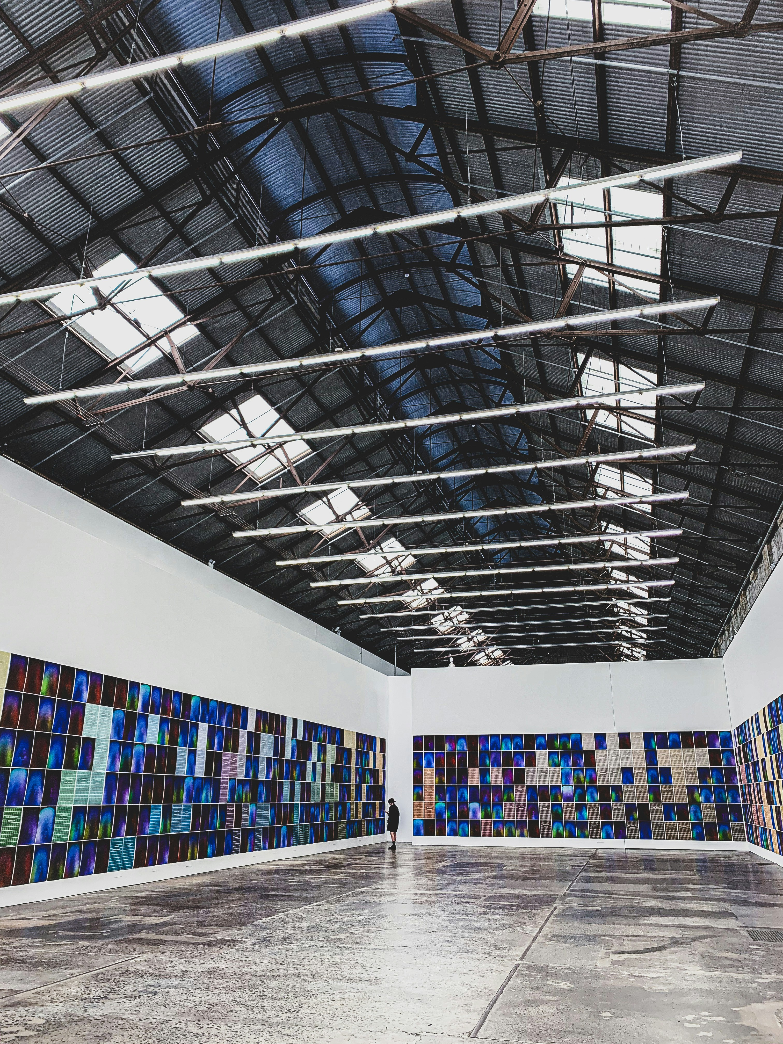people walking inside building with books on shelves