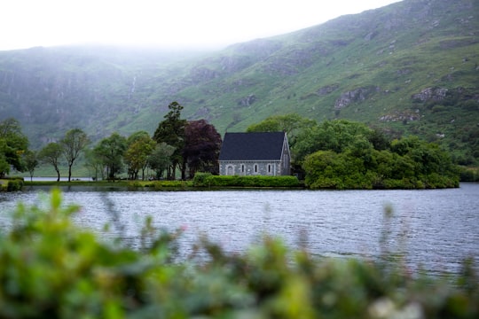 white and black house near green trees and mountain during daytime in Gougane Barra Hotel Ballingeary Hotel Ireland